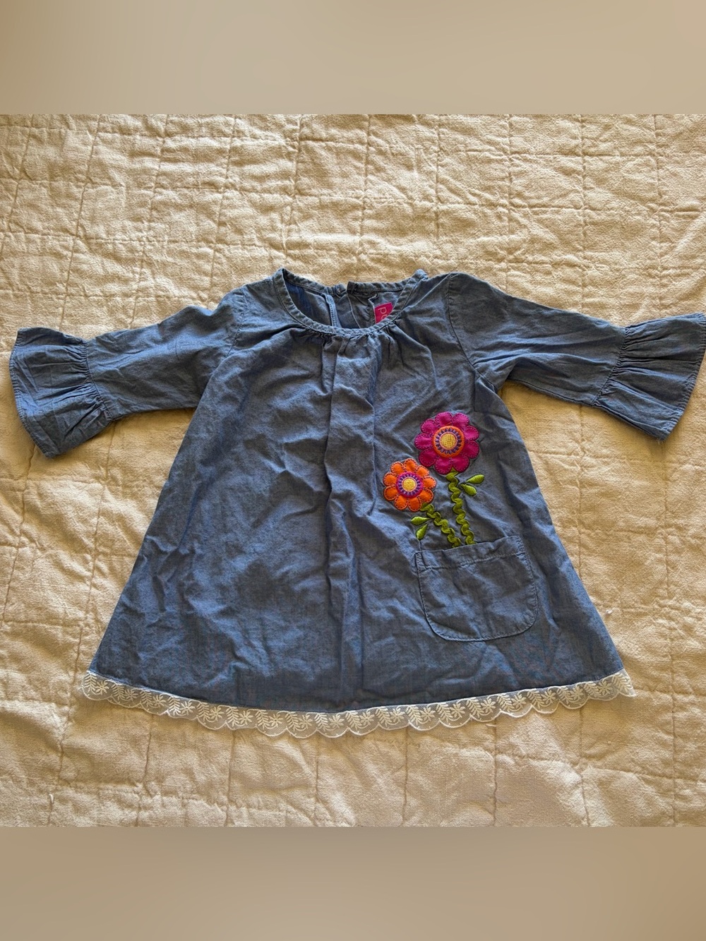 Girls Blue chambray dress with flower appliqué, flared sleeves, and floral lace